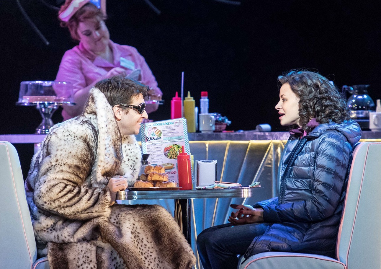 Phil Connors (Andy Karl) and Rita Hanson (Carlyss Peer). Photo by Manuel Harlan. This is an example of something that changed during previews (the booth was removed, with Phil and Rita sitting on stools at the counter).